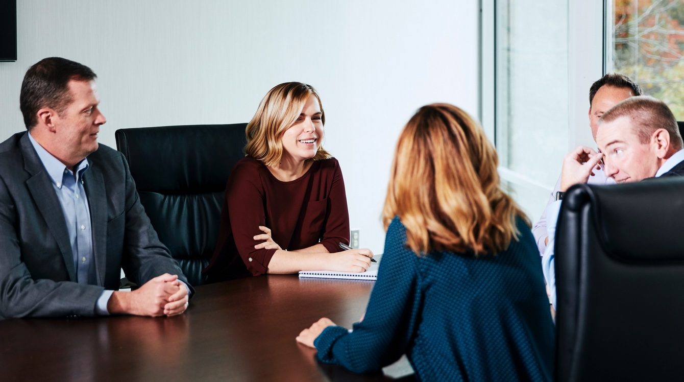 Team members of Harris Financial metting around a table